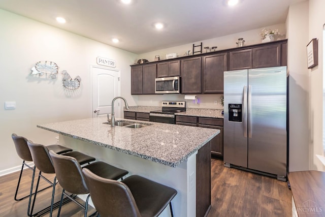 40 Glen Mary Dr, Pierce Twp, OH 45102 - kitchen featuring appliances with stainless steel finishes, a sink, dark brown cabinets, a center island with sink, and dark wood finished floors