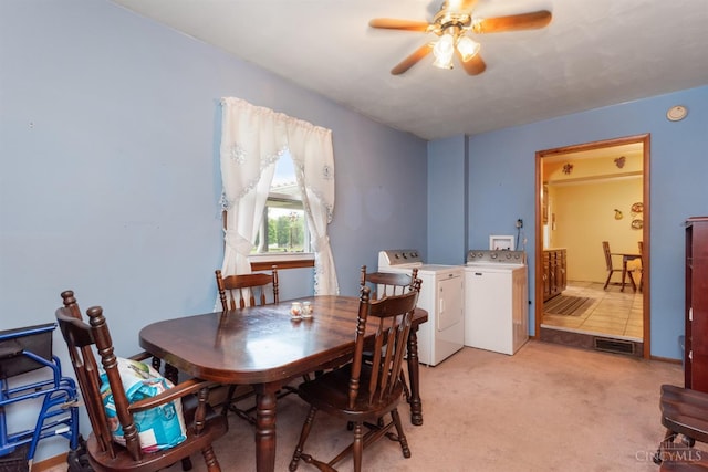 dining room with washer and dryer, a ceiling fan, and light colored carpet