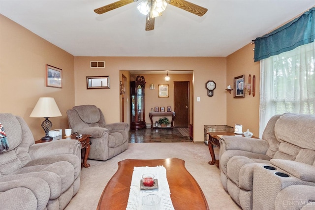 carpeted living area featuring ceiling fan