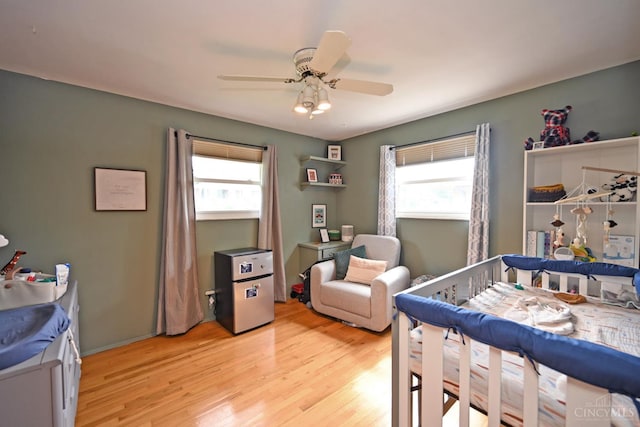 5638 Victoryview Ln, Delhi Twp, OH 45233 - bedroom featuring multiple windows, light wood finished floors, and ceiling fan