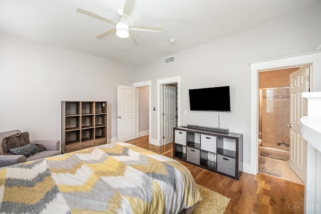 709 E Mcmillan St Unit 1, Cincinnati, OH 45206 - bedroom with wood finished floors, ceiling fan, baseboards, and ensuite bath