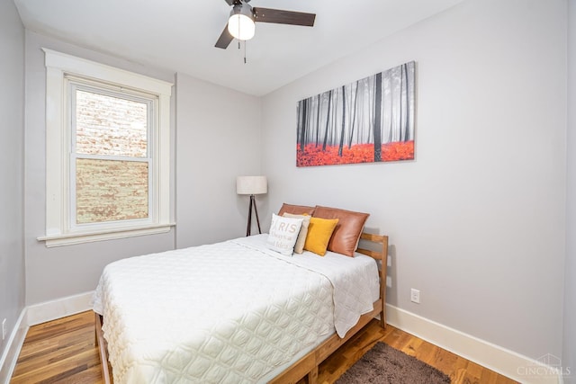 709 E Mcmillan St Unit 1, Cincinnati, OH 45206 - bedroom with baseboards, wood finished floors, and ceiling fan