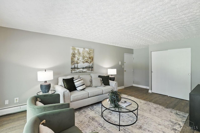 6607 Hearne Rd Unit 90, Green Twp, OH 45248 - living room featuring a textured ceiling, wood finished floors, baseboards, and baseboard heating