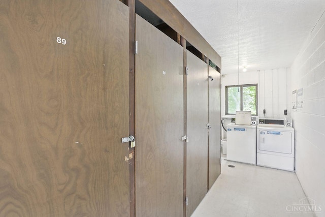 6607 Hearne Rd Unit 90, Green Twp, OH 45248 - shared laundry room with separate washer and dryer and a textured ceiling