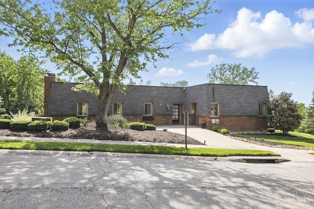 6607 Hearne Rd Unit 90, Green Twp, OH 45248 - view of front of house featuring a chimney, brick siding, and mansard roof