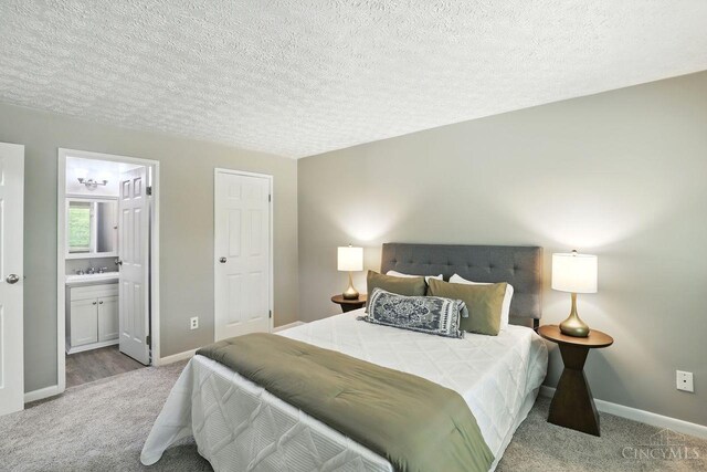 6607 Hearne Rd Unit 90, Green Twp, OH 45248 - carpeted bedroom featuring a textured ceiling, baseboards, and connected bathroom