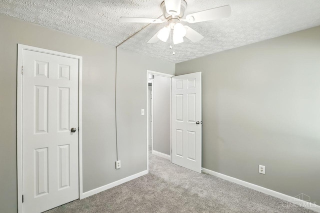 6607 Hearne Rd Unit 90, Green Twp, OH 45248 - unfurnished bedroom with a textured ceiling, carpet flooring, baseboards, and a ceiling fan