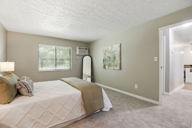 6607 Hearne Rd Unit 90, Green Twp, OH 45248 - carpeted bedroom with a wall mounted air conditioner, baseboards, and a textured ceiling