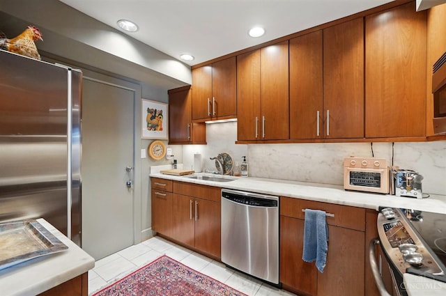 1617 E Mcmillan St Unit 605, Cincinnati, OH 45206 - kitchen with appliances with stainless steel finishes, light countertops, tasteful backsplash, light tile patterned flooring, and recessed lighting