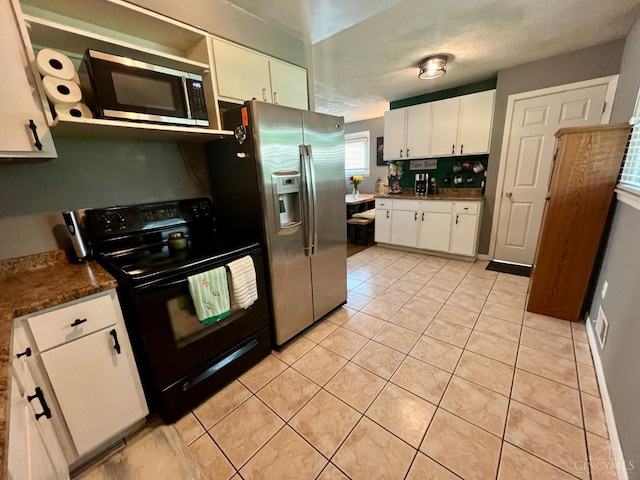 8608 Dundalk Ct, Sycamore Twp, OH 45236 - kitchen featuring appliances with stainless steel finishes, white cabinetry, light tile patterned flooring, and dark countertops