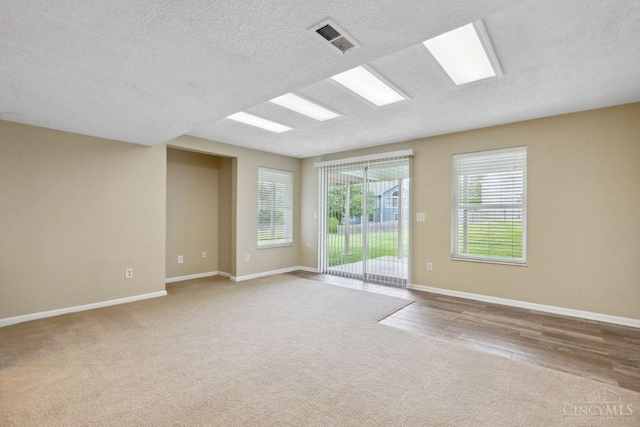 5 Artesian Ct, Springboro, OH 45066 - empty room with a textured ceiling, carpet, baseboards, and wood finished floors