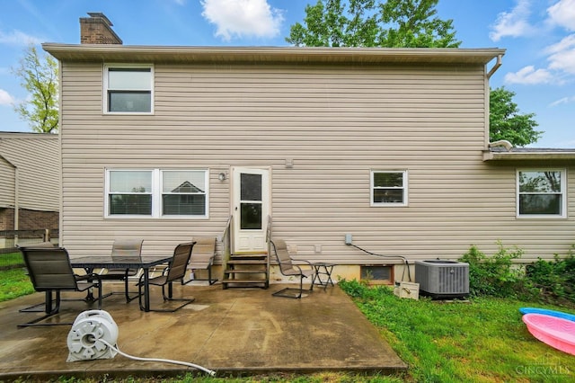 12056 Hazelhurst Ln, Springfield Twp, OH 45240 - back of house featuring entry steps, central AC unit, a chimney, and a patio area