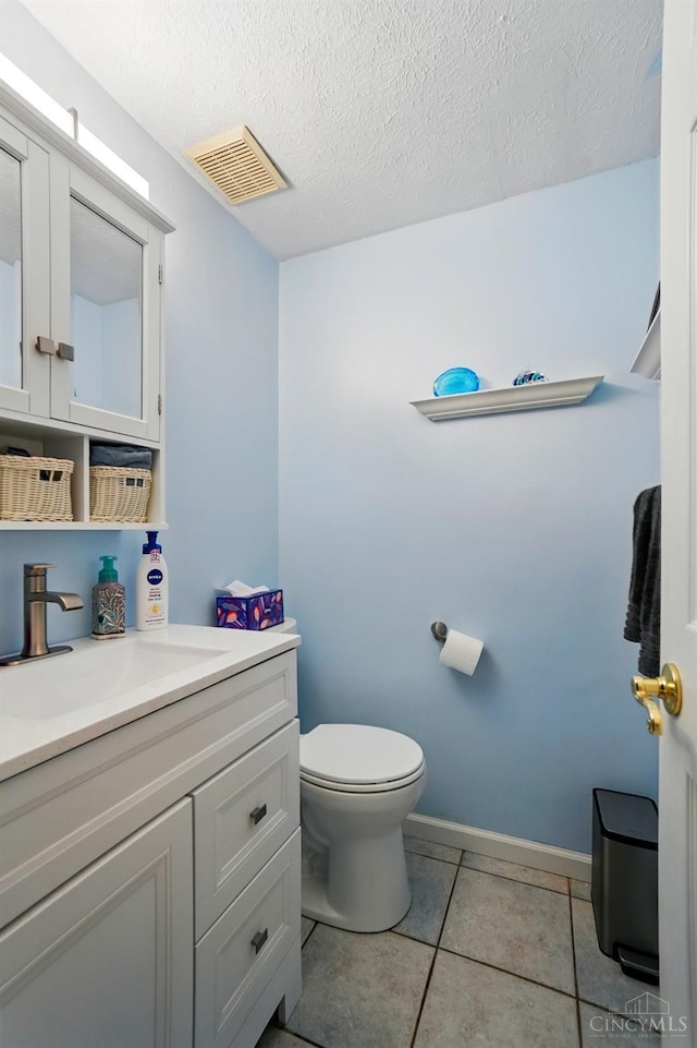 12056 Hazelhurst Ln, Springfield Twp, OH 45240 - bathroom with toilet, vanity, tile patterned floors, a textured ceiling, and baseboards