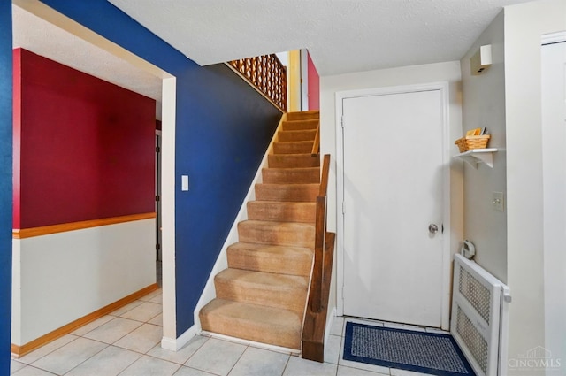 12056 Hazelhurst Ln, Springfield Twp, OH 45240 - stairway featuring baseboards, tile patterned floors, and a textured ceiling