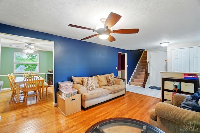 12056 Hazelhurst Ln, Springfield Twp, OH 45240 - living area featuring a ceiling fan, stairs, wood finished floors, a textured ceiling, and baseboards