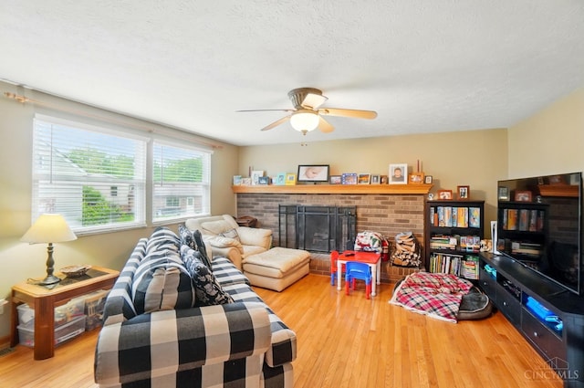 12056 Hazelhurst Ln, Springfield Twp, OH 45240 - living area featuring wood finished floors, ceiling fan, and a fireplace