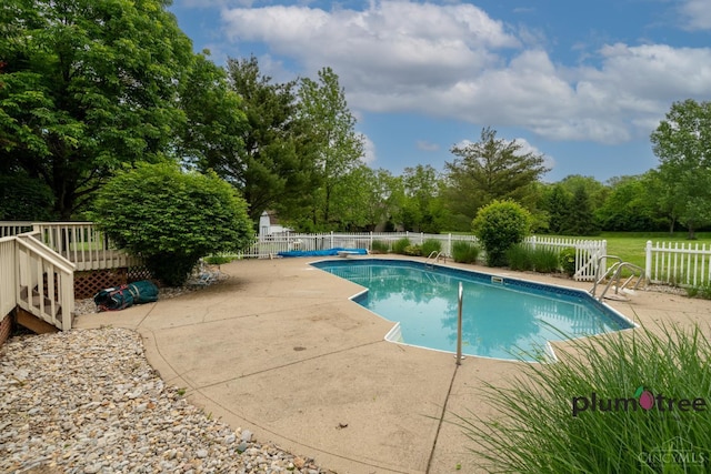378 Natalie Ln, Turtle Creek Twp, OH 45036 - view of pool with fence, a patio area, a wooden deck, and view of scattered trees