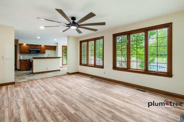 378 Natalie Ln, Turtle Creek Twp, OH 45036 - unfurnished living room featuring light wood-type flooring, baseboards, ceiling fan, and recessed lighting