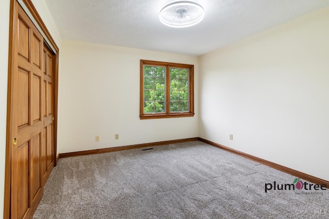 378 Natalie Ln, Turtle Creek Twp, OH 45036 - unfurnished bedroom featuring carpet, baseboards, and a textured ceiling