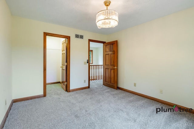378 Natalie Ln, Turtle Creek Twp, OH 45036 - unfurnished room with carpet, a chandelier, and baseboards