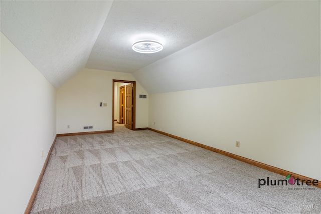 378 Natalie Ln, Turtle Creek Twp, OH 45036 - bonus room with light carpet, vaulted ceiling, a textured ceiling, and baseboards