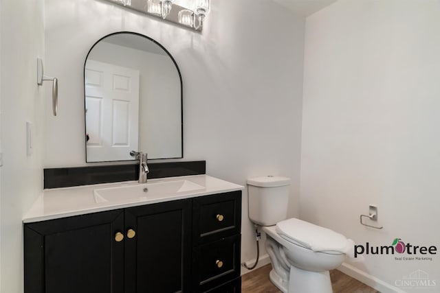 378 Natalie Ln, Turtle Creek Twp, OH 45036 - bathroom with toilet, wood finished floors, vanity, and baseboards