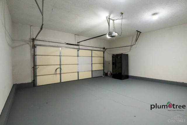 378 Natalie Ln, Turtle Creek Twp, OH 45036 - garage featuring a garage door opener and baseboards