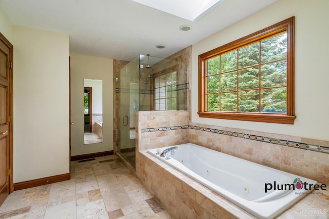 378 Natalie Ln, Turtle Creek Twp, OH 45036 - bathroom featuring healthy amount of natural light, a whirlpool tub, a skylight, and a stall shower