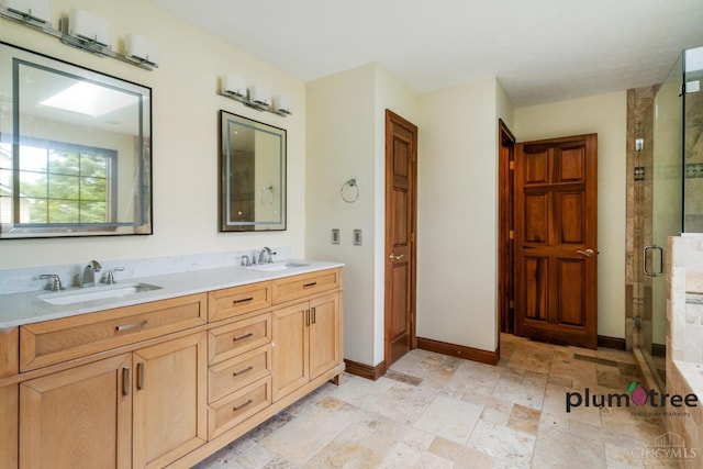 378 Natalie Ln, Turtle Creek Twp, OH 45036 - bathroom featuring a stall shower, baseboards, stone tile floors, and double vanity
