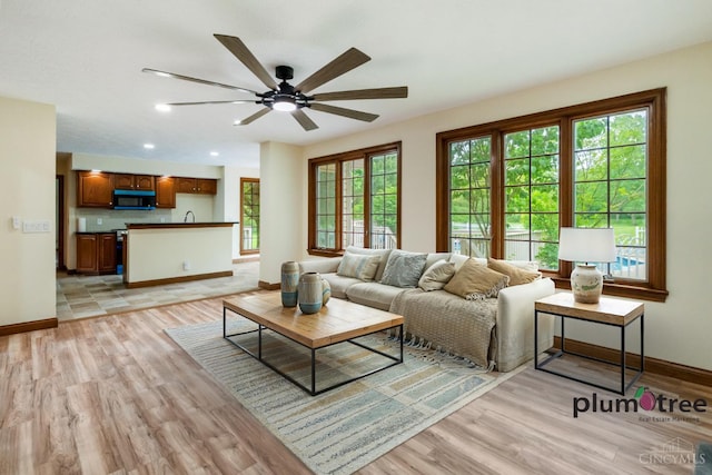 378 Natalie Ln, Turtle Creek Twp, OH 45036 - living room featuring light wood-style flooring, baseboards, ceiling fan, and recessed lighting