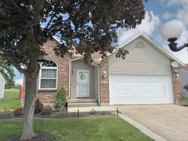 232 Choctaw Cir, Franklin, OH 45005 - view of front of home with concrete driveway, brick siding, an attached garage, and a front lawn