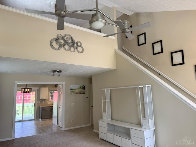232 Choctaw Cir, Franklin, OH 45005 - unfurnished living room with a ceiling fan, light carpet, vaulted ceiling, baseboards, and light tile patterned floors