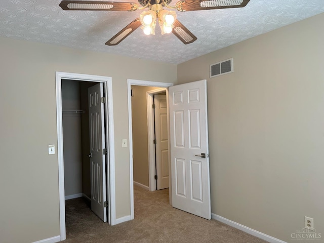 232 Choctaw Cir, Franklin, OH 45005 - unfurnished bedroom with carpet, a spacious closet, a closet, baseboards, and a textured ceiling