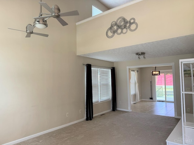 232 Choctaw Cir, Franklin, OH 45005 - carpeted spare room featuring a ceiling fan, baseboards, and a towering ceiling