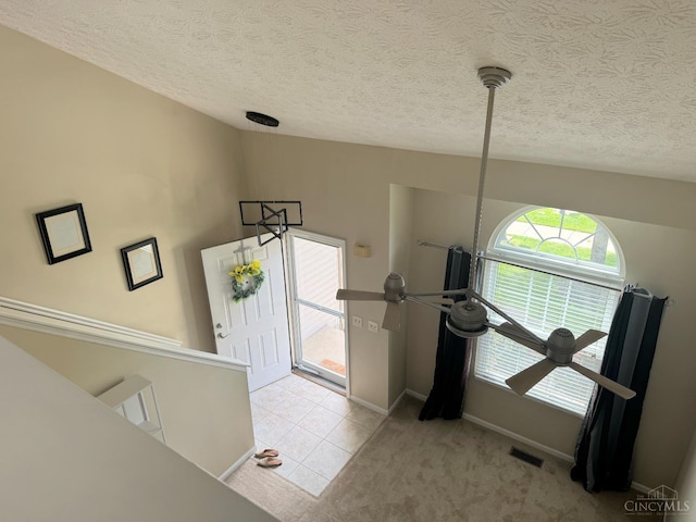 232 Choctaw Cir, Franklin, OH 45005 - foyer with a textured ceiling, baseboards, light tile patterned floors, and light carpet