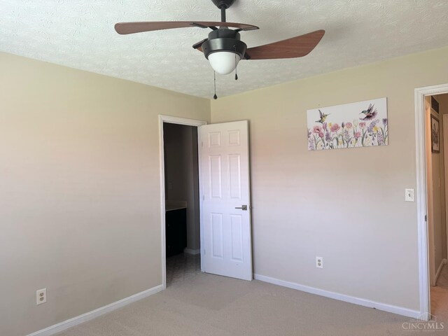 232 Choctaw Cir, Franklin, OH 45005 - unfurnished bedroom featuring light colored carpet, baseboards, a textured ceiling, and a ceiling fan