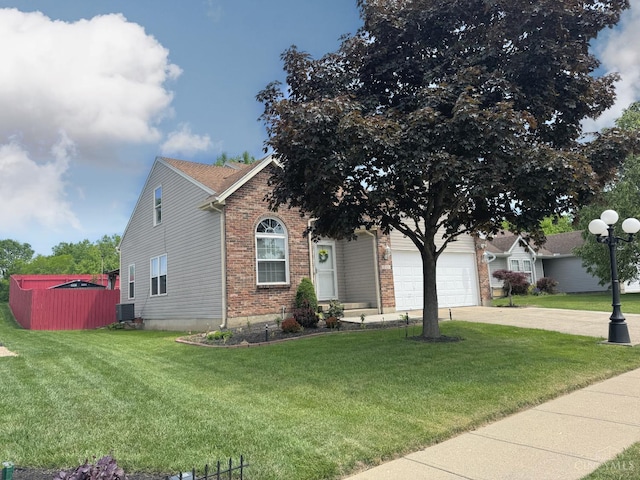 232 Choctaw Cir, Franklin, OH 45005 - view of property hidden behind natural elements featuring driveway, an attached garage, brick siding, a front lawn, and central AC unit