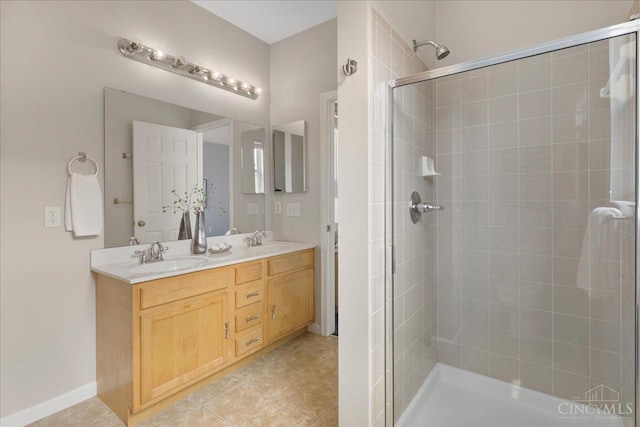 1441 Laurel Park Dr, Cincinnati, OH 45214 - bathroom featuring a shower stall, double vanity, baseboards, and tile patterned flooring