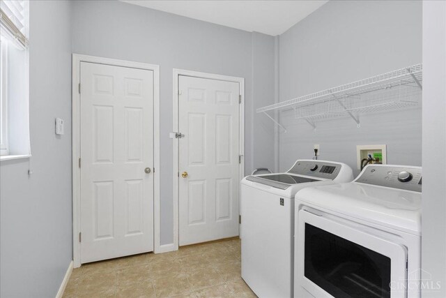 1441 Laurel Park Dr, Cincinnati, OH 45214 - laundry area with washing machine and clothes dryer, baseboards, and light tile patterned flooring