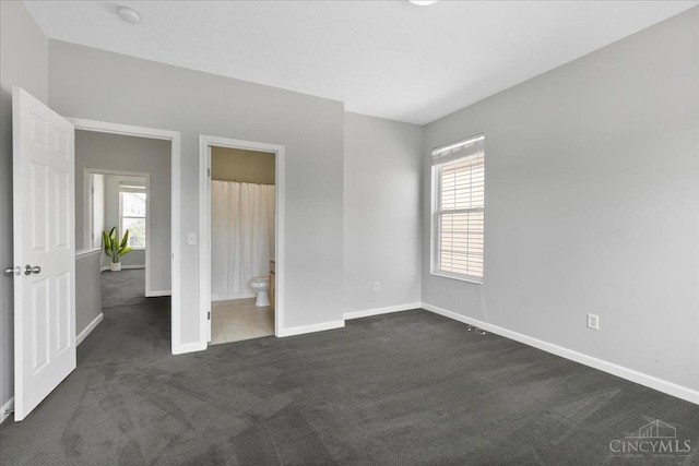 1441 Laurel Park Dr, Cincinnati, OH 45214 - unfurnished bedroom featuring dark carpet, baseboards, and connected bathroom