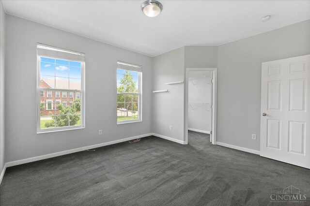 1441 Laurel Park Dr, Cincinnati, OH 45214 - unfurnished bedroom with dark carpet, baseboards, and a spacious closet