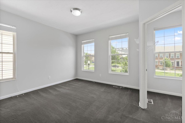 1441 Laurel Park Dr, Cincinnati, OH 45214 - spare room featuring dark colored carpet, plenty of natural light, and baseboards