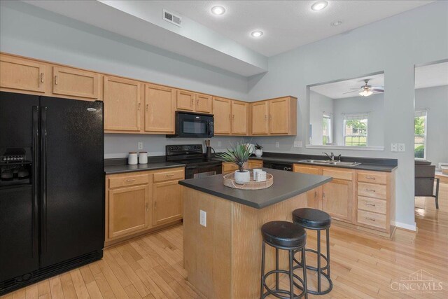 1441 Laurel Park Dr, Cincinnati, OH 45214 - kitchen with black appliances, dark countertops, light brown cabinets, and recessed lighting