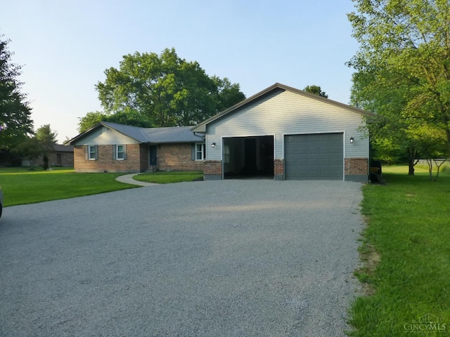 7274 Frey Rd, Goshen Twp, OH 45122 - ranch-style home with brick siding, a front lawn, an attached garage, and driveway