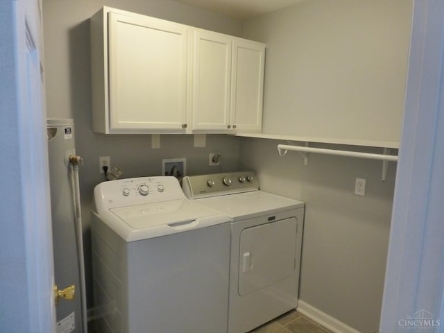 7274 Frey Rd, Goshen Twp, OH 45122 - laundry area with washing machine and clothes dryer, cabinet space, and water heater