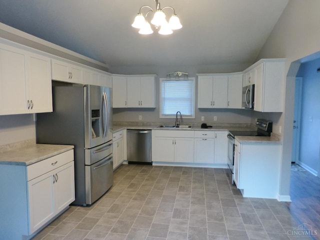7274 Frey Rd, Goshen Twp, OH 45122 - kitchen with stainless steel appliances, a chandelier, white cabinetry, light countertops, and hanging light fixtures