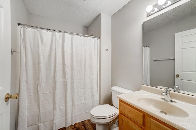 10350 W Rd Unit 34, Harrison, OH 45030 - full bathroom featuring toilet, vanity, a textured ceiling, wood finished floors, and curtained shower