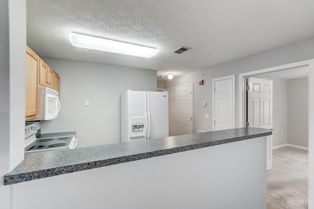 10350 W Rd Unit 34, Harrison, OH 45030 - kitchen with white appliances, a peninsula, dark countertops, light brown cabinetry, and light carpet