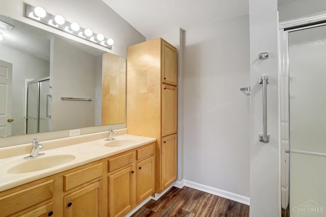 10350 W Rd Unit 34, Harrison, OH 45030 - bathroom with wood finished floors, a stall shower, double vanity, and baseboards