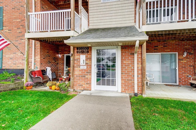 10350 W Rd Unit 34, Harrison, OH 45030 - entrance to property featuring a balcony, brick siding, roof with shingles, and a lawn